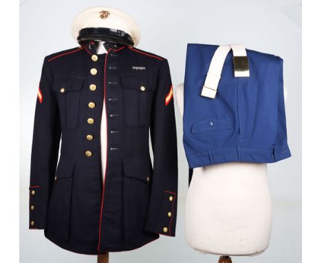 US Marine Corps Dress Uniform and Peaked Cap, dark blue four pocket dress tunic, with the original insignia. Accompanied by d