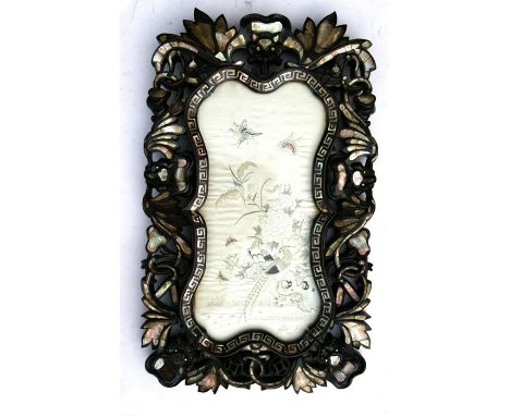 A Chinese silk embroidered panel decorated with birds, pheasants and butterflies, mounted in a mother of pearl inlaid hardwoo