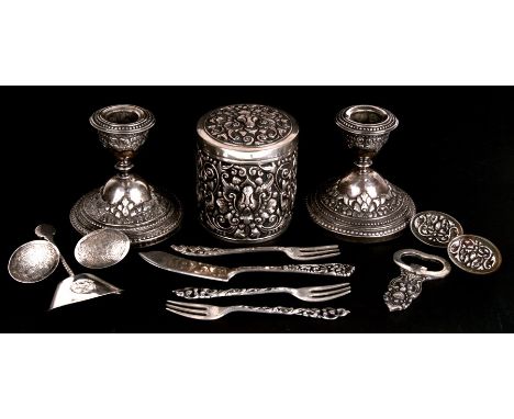 A quantity of Indonesian 800 grade silver items, including dwarf candlesticks, tea caddy, and cutlery items.