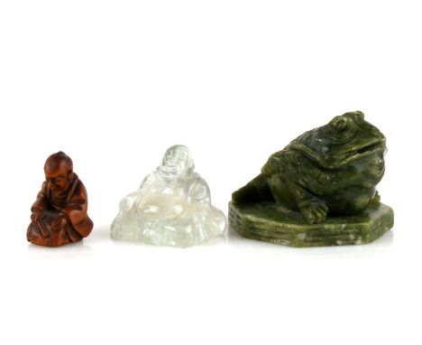 A Chinese carved rock crystal Buddha, 4cms (1.5ins) high; together with a green hardstone carving in the form of a stylised t