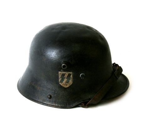 From a private collection, an M1916 Waffen SS German helmet with Nazi Party and SS decals, with original (repaired) chin stra