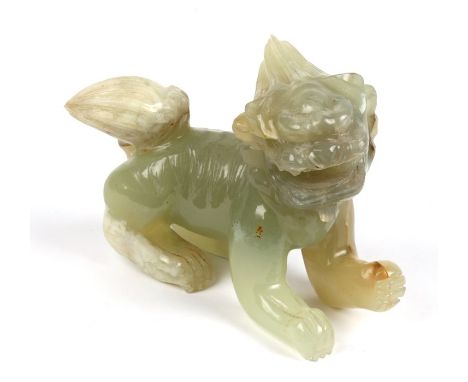 A Chinese jade or hardstone figure of a temple lion, 14cms (5.5ins) long.