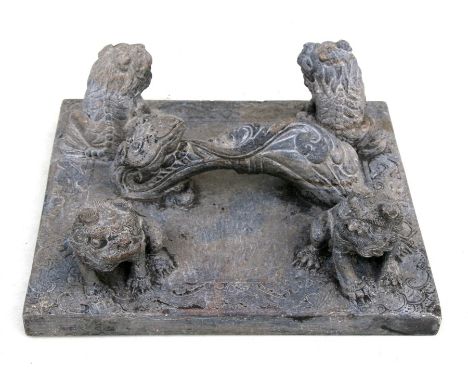 A large Chinese soapstone scroll weight carved with four fo dogs and a rui sceptre handle, 29cms (11.5ins) diameter.