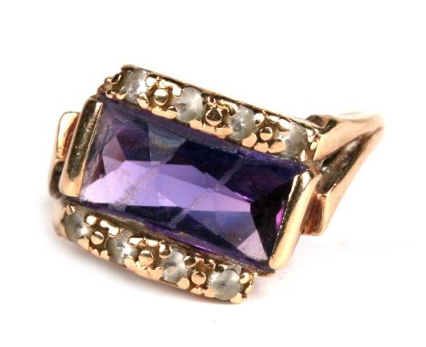 A 9ct gold ring set with a rectangular amethyst flanked by diamonds, approx UK size 'K'.