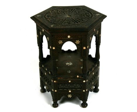 An Ottoman Turkish hexagonal occasional table inlaid with mother of pearl and having Islamic script,  44cms (17.25ins) diamet