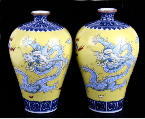 A pair of Chinese yellow ground meiping vases, each enamelled with the image of two large dragons chasing a flaming pearl. Bo