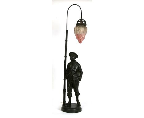 A bronzed spelter figural lamp in the form of a young boy holding a book beside a lamp post, 97cms (38ins) high.