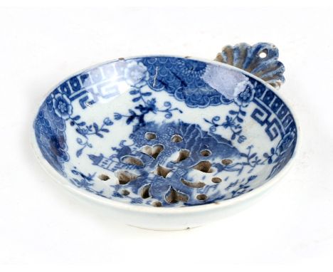 An 18th century blue &amp; white tea strainer, probably Worcester First Period, 8cms (3.1ins) diameter.Condition ReportCouple