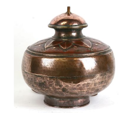 A large tinned copper table lamp; together with a vellum shade, 41cms (16ins) high.