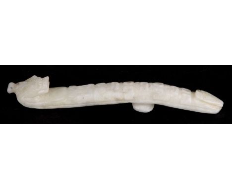 A Chinese jade or hardstone belt hook in the form of a dragon, 11cms (4.25ins) long.