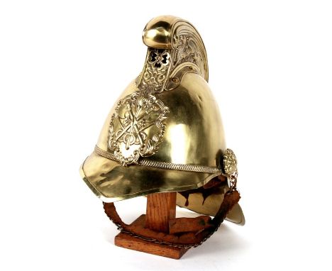 A late 19th / early 20th century Merryweather style fireman's helmet, the high comb with dragon decoration, applied cross axe