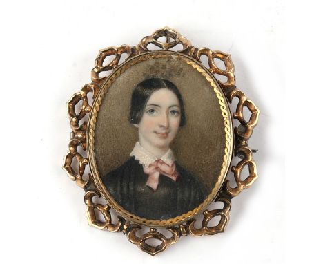 A 19th century glazed back portrait miniature brooch of a young girl, within a pierced 9ct gold frame (unmarked but tested). 