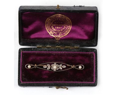 An Art Nouveau 18ct gold, platinum, pearl and old cut diamond bar brooch, the centre as a flower with leaves. 3.3g. 5cm (2 in