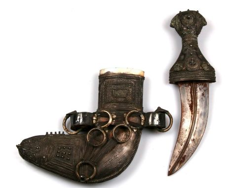 A Saudi Arabian jambiya dagger with silver hilt and scabbard. Blade length 18cms (7ins)
