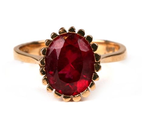 An 18ct gold ring set with a large oval ruby, approx UK size 'M'.Condition ReportMinor surface scratches otherwise good condi