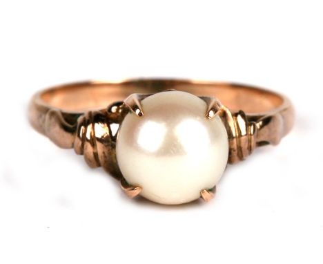 A 14ct gold ring set with a single pearl, approx UK size 'O'.