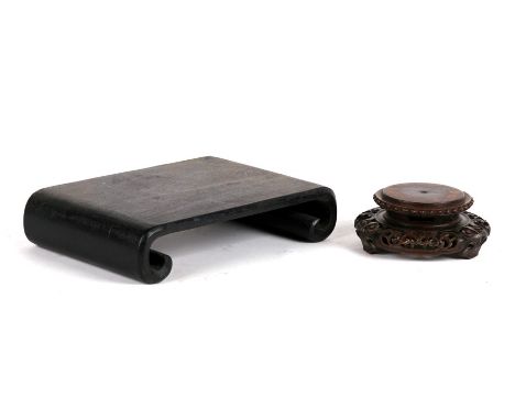 A Chinese pierced hardwood vase stand, 10cm (4ins) high; together with a scroll end vase stand, 21cms *8.25ins) wide (2).