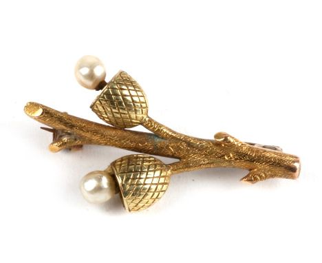 An early 20th century novelty 15ct gold and pearl brooch modelled as acorns on a branch, 3.4g, 3.3cm (1.25 ins) long.