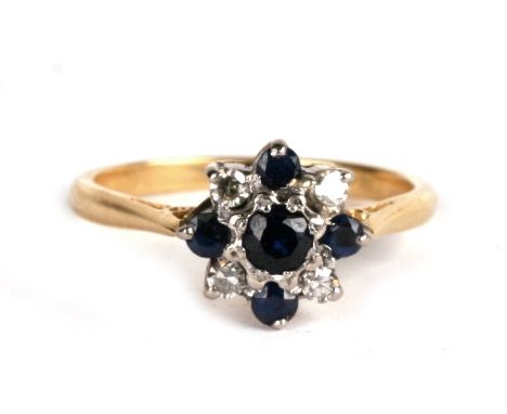 An 18ct gold, diamond and sapphire daisy head ring, 3.1g. Approx. UK size K, 