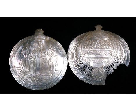 A pair of 19th century carved mother of pearl shells, each depicting religious scenes, (a/f) 11.5cms (4.5ins) diameter.