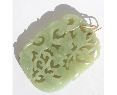 A Chinese pieced and carved jade pendant depicting a phoenix, dragon and lotus flowers, on a pair of unmarked gold suspension