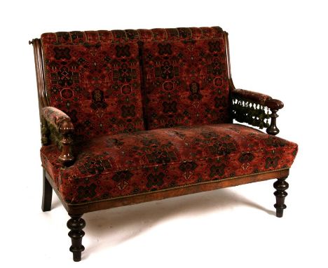 A 19th century walnut upholstered two-seater sofa on turned front supports, 130cms (51ins) wide.