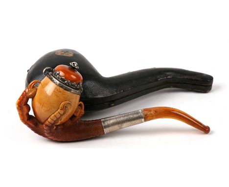 A large Meerschaum pipe carved in the form of a bird’s claw, with silver mounted amber cover and amber mouthpiece. In origina
