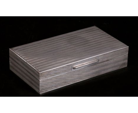 A continental 800 grade silver table cigarette box with engine turned decoration, 18cms (7ins) wide.