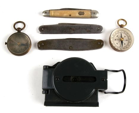 Two brass pocket / fob compasses; together with a compass and three penknives.