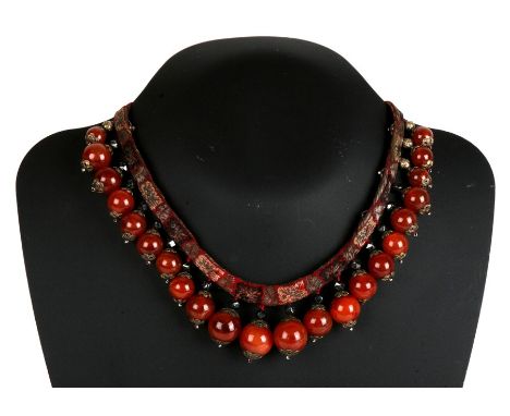 A 19th century Chinese gold mounted graduated carnelian bead, obsidian and silver gilt silk necklace. 38cm (15 ins) long.