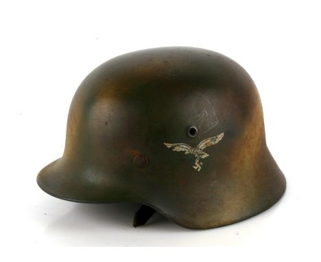 A WW2 Third Reich Luftwaffe combat helmet with Normandy camouflage. Double decals with liner and chin strap. Makers mark ET64