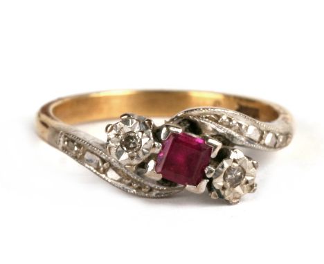 An 18ct gold ruby and diamond crossover ring, approx UK size 'M', 4.04g.