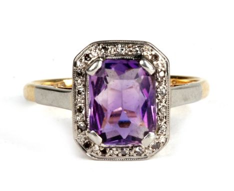 An 18ct gold and platinum ring , with central amethyst surrounded by diamond chips. 3.8g