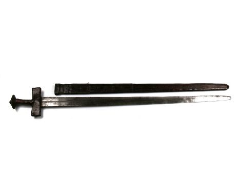 A 19th century North West African Tuareg Takouba double edged sword with leather covered hilt and crosspiece in its leather s