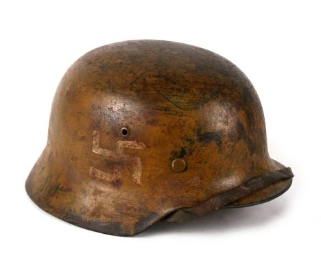 From a private collection, an M1935 Third Reich German helmet with hand painted Swastikas &amp; DERNA to the rear. Production