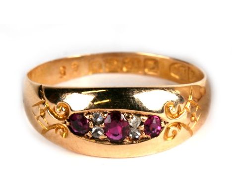 An 18ct gold, ruby and diamond 7 stone ring, Birmingham 1907, 2.4g. Approx. UK size O. 