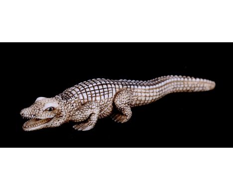 A late 19th / early 20th century Japanese ivory netsuke in the form of a crocodile, signed to underside, 12.5cms (5ins) long.