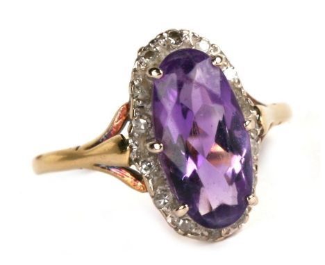An 18ct gold diamond and amethyst ring, approx UK size 'S', 4.8g.