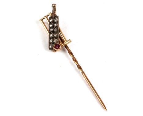 A novelty 9ct gold stick pin modelled as a cricket bat and ball in front of a set of stumps, the bat set with 11 diamonds and