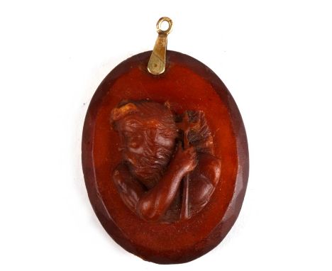 A 19th century facet cut amber pendant carved with a portrait of Neptune.  Weighs 14.2g.  5 by 4cm ( 2 by 1.5 ins)