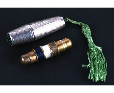A continental sterling silver pendant necessaire, green glass topped thimble lid containing a cotton bobbin and miniature fol