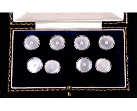 A cased set of 18ct gold cufflinks and four buttons, with mother of pearl fronts set with a central pearl. 16.8g