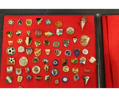 An indexed album of 61 German and Eastern European football supporters enamel badges, including Lokomotive Leipzig and Meisse