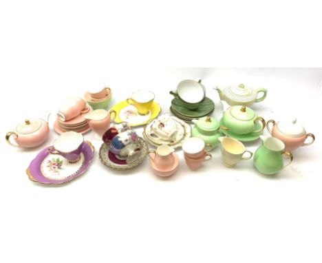 A Wedgwood bone china pink glazed teaset for six, comprising teapot, twin handled sucrier with cover, cream jug, milk jug, sm