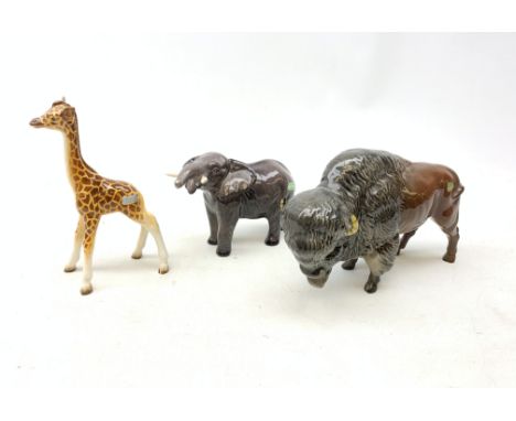 A group of three Beswick figurines, comprising Bison, Elephant and Giraffe, each with printed mark beneath, Bison H14.5cm. Co