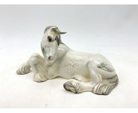 A Beswick figurine, modelled as a seated dapple grey Shire horse, with printed mark to base, L25cm. Condition Report Click he