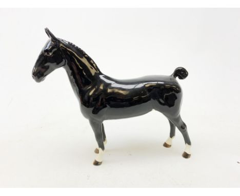 A Beswick figurine, modelled as a black Hackney horse, with printed mark beneath, H20cm.  Condition Report Click here for fur