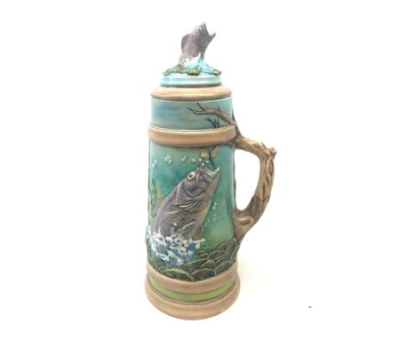 Large earthenware stein moulded with a continuous underwater landscape of fish amongst grasses and branches with fish finial,