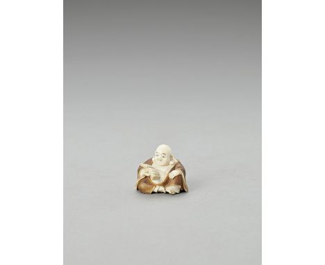   KOGYOKU: A TOKYO-SCHOOL STAINED IVORY NETSUKE OF HOTEI READING A BOOK  By Kogyoku, signed Kogyoku  Japan, Tokyo, Meiji peri