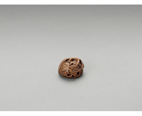  MASANAO: A WOOD NETSUKE OF A DRAGON INSIDE A MIKAN  Signed Masanao  Japan, Ise-Yamada, 19th century    Deftly carved as a m